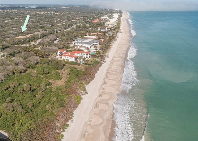 drone / aerial view featuring a beach view and a water view