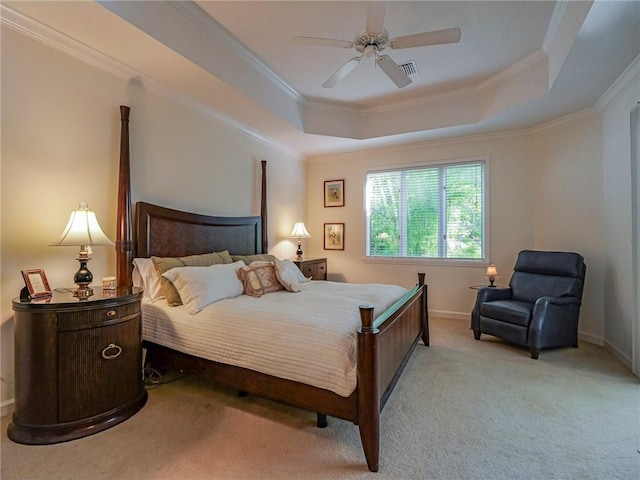 carpeted bedroom featuring crown molding, ceiling fan, and a tray ceiling