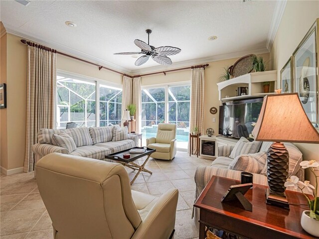 tiled living room with a textured ceiling, ornamental molding, and ceiling fan