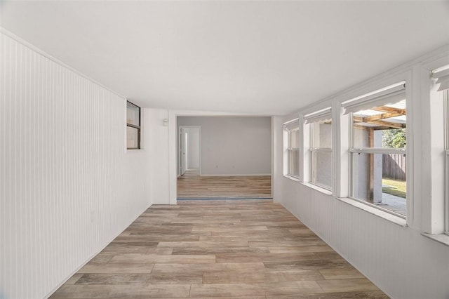 hallway with light hardwood / wood-style floors