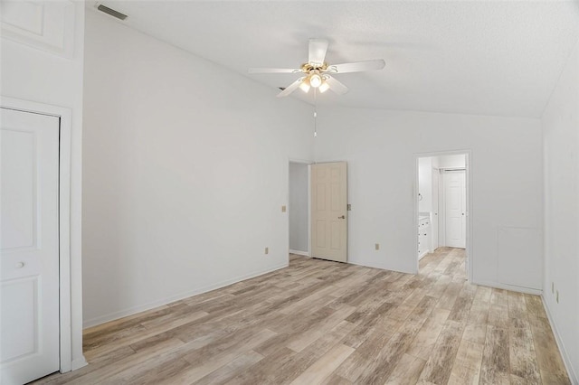 empty room with vaulted ceiling, light hardwood / wood-style floors, and ceiling fan