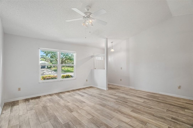 unfurnished room with ceiling fan, light hardwood / wood-style flooring, and a textured ceiling