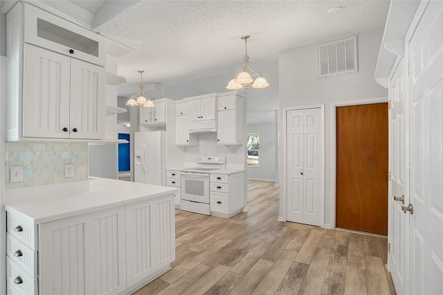 kitchen featuring white cabinetry, pendant lighting, white appliances, and light hardwood / wood-style flooring