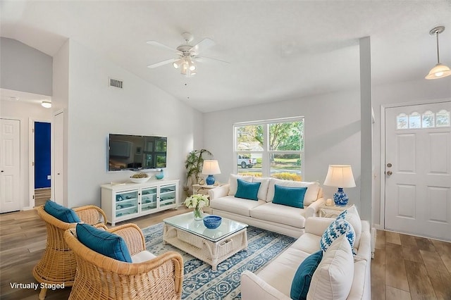 living room featuring lofted ceiling, hardwood / wood-style floors, and ceiling fan