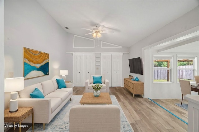 living room featuring vaulted ceiling, ceiling fan, and light hardwood / wood-style floors