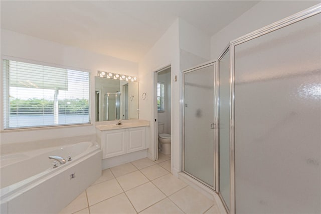 full bathroom featuring toilet, vanity, tile patterned flooring, and separate shower and tub