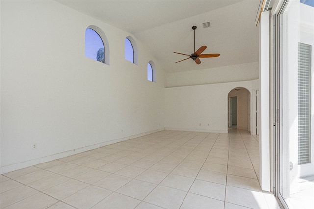 tiled empty room featuring high vaulted ceiling and ceiling fan