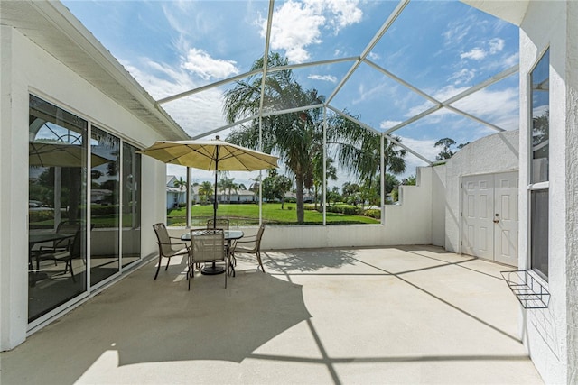 view of patio with glass enclosure