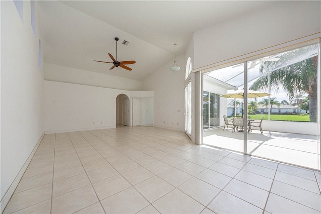 unfurnished living room with light tile patterned flooring, ceiling fan, and high vaulted ceiling