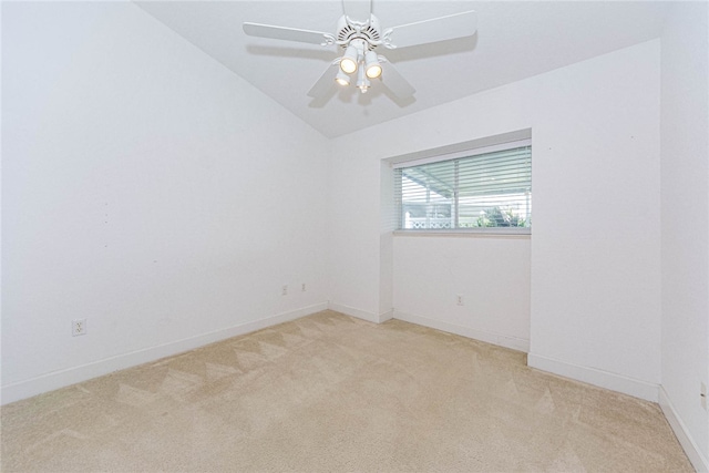 carpeted empty room with vaulted ceiling and ceiling fan