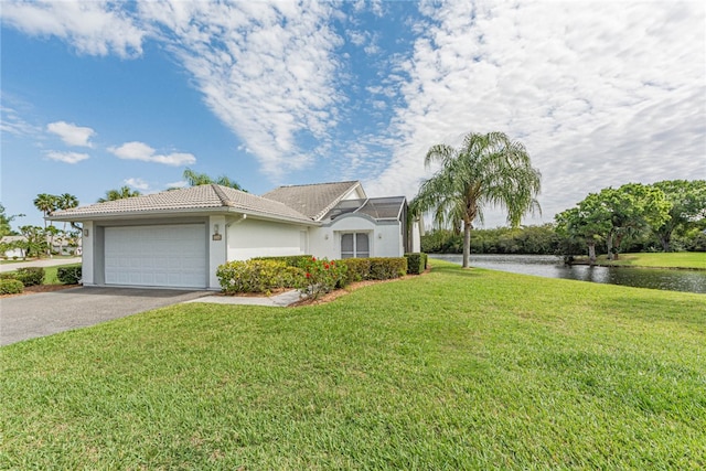 single story home featuring a garage, a water view, and a front lawn