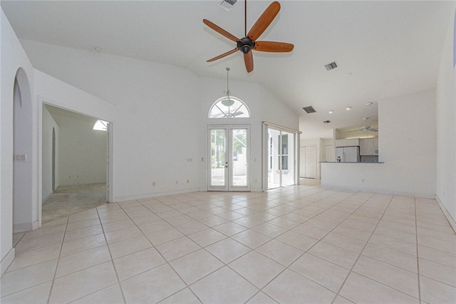 unfurnished living room featuring high vaulted ceiling, french doors, light tile patterned floors, and ceiling fan