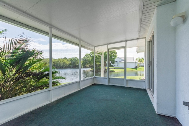 unfurnished sunroom with a water view