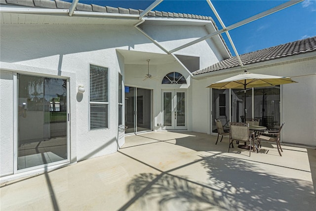 back of house featuring a lanai, french doors, ceiling fan, and a patio area