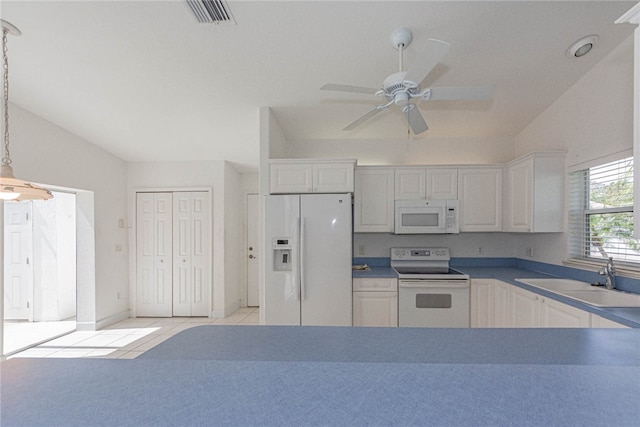 kitchen featuring vaulted ceiling, white cabinets, hanging light fixtures, sink, and white appliances