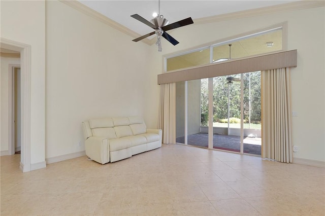 unfurnished living room featuring ceiling fan, ornamental molding, and a high ceiling