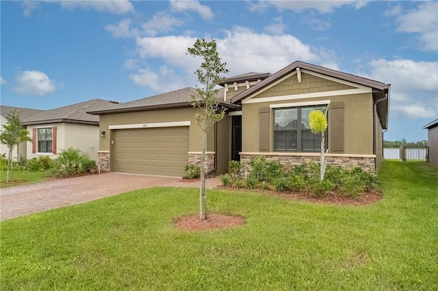 view of front facade with a garage and a front lawn