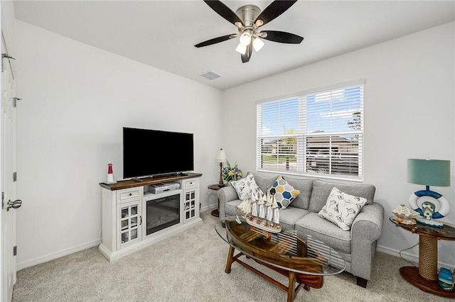 carpeted living room featuring ceiling fan