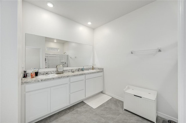 bathroom featuring vanity and an enclosed shower