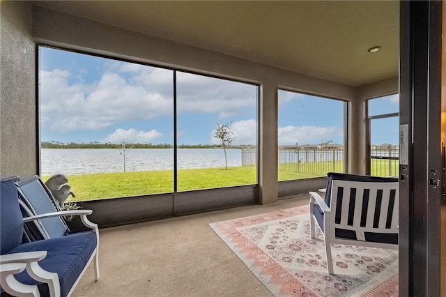 sunroom / solarium featuring a water view