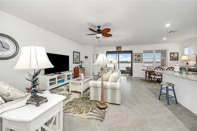 living room featuring ceiling fan and light tile patterned floors