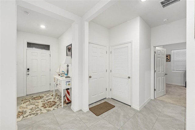 entryway with light tile patterned floors