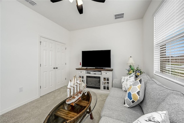 living room featuring carpet flooring and ceiling fan