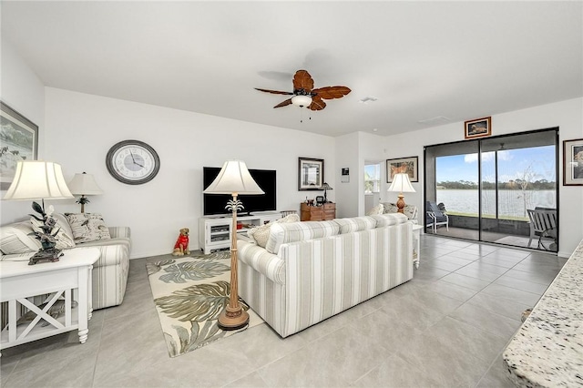 living room with ceiling fan and light tile patterned floors