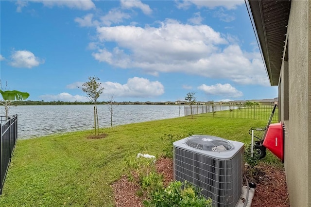 view of yard featuring cooling unit and a water view