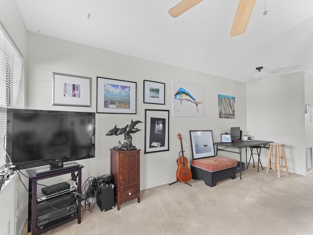 interior space featuring light colored carpet and ceiling fan