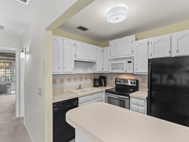 kitchen with light colored carpet, black appliances, sink, tasteful backsplash, and white cabinetry