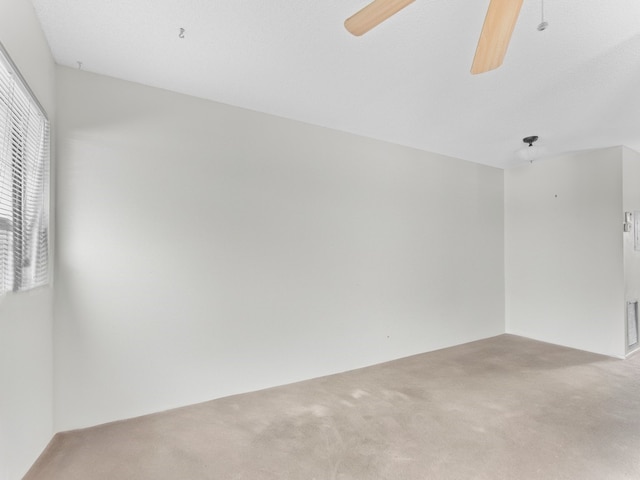 carpeted empty room with a textured ceiling and ceiling fan