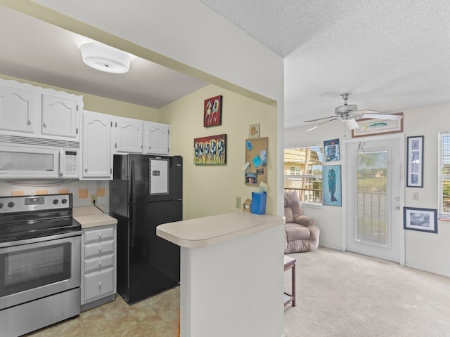 kitchen with black refrigerator, white cabinets, kitchen peninsula, a kitchen breakfast bar, and stainless steel electric stove