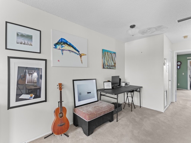 office with a textured ceiling and light carpet