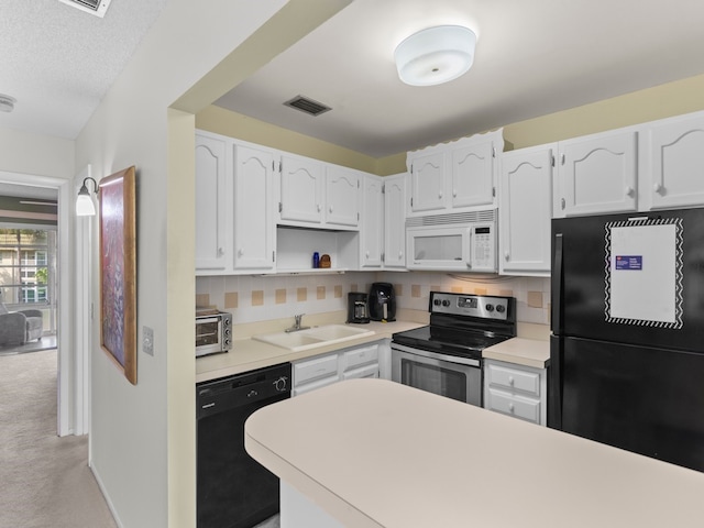 kitchen with black appliances, tasteful backsplash, sink, white cabinets, and light colored carpet