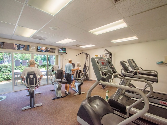 workout area with a drop ceiling and carpet floors