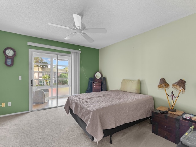 bedroom featuring a textured ceiling, access to outside, carpet floors, and ceiling fan