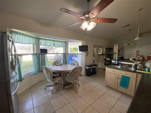 tiled dining space with lofted ceiling, sink, a wealth of natural light, and ceiling fan