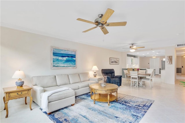 living area with a ceiling fan, visible vents, crown molding, and light tile patterned flooring