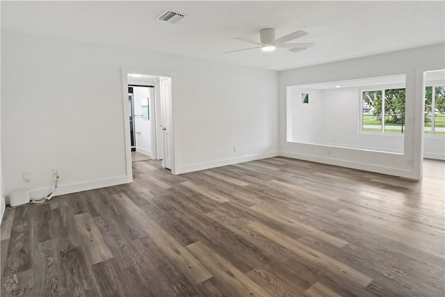 empty room featuring dark wood-type flooring and ceiling fan