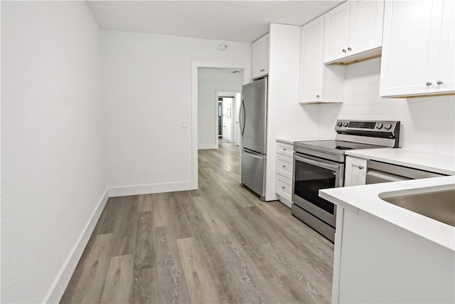 kitchen with white cabinetry, appliances with stainless steel finishes, light countertops, and baseboards