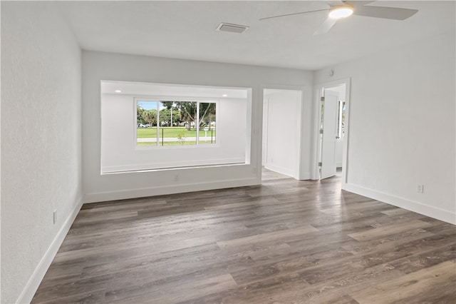 spare room featuring ceiling fan and dark hardwood / wood-style floors