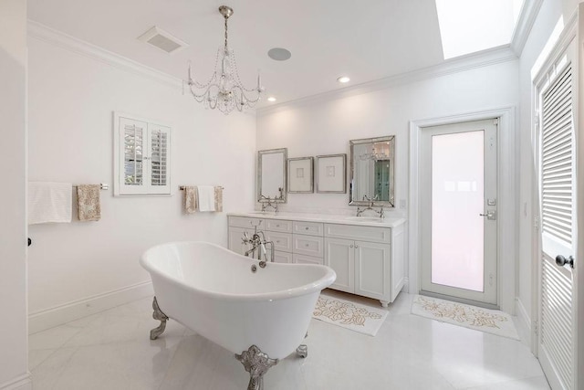 bathroom with a chandelier, a soaking tub, double vanity, baseboards, and ornamental molding