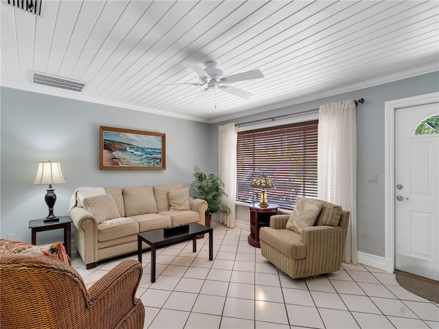 living area featuring light tile patterned floors, ornamental molding, ceiling fan, and visible vents