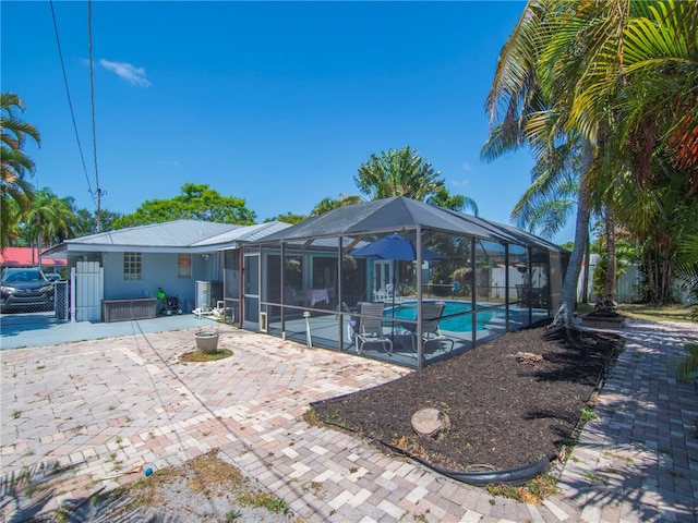 pool with a lanai and a patio area