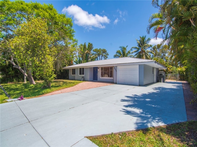 ranch-style house with a garage, fence, a front lawn, concrete driveway, and stucco siding