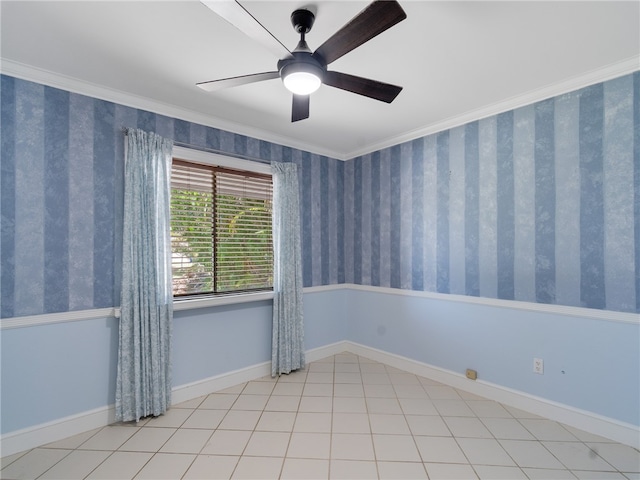 spare room featuring baseboards, ceiling fan, and ornamental molding