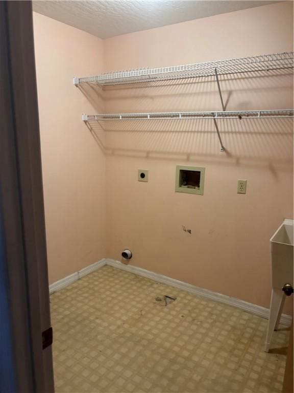washroom with electric dryer hookup, tile patterned floors, baseboards, hookup for a washing machine, and laundry area