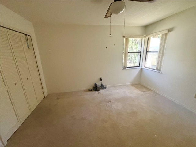unfurnished bedroom featuring a closet and ceiling fan