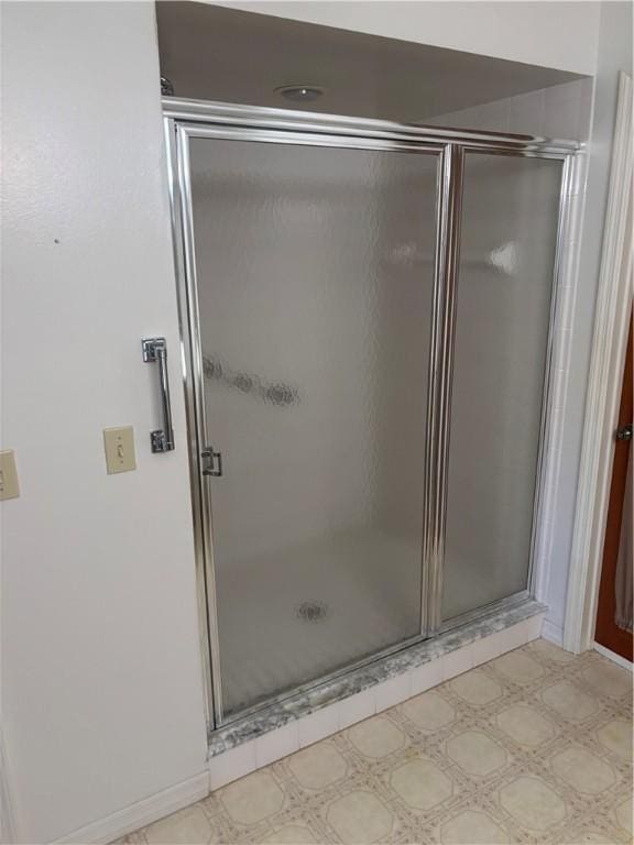 bathroom featuring tile patterned floors and a stall shower